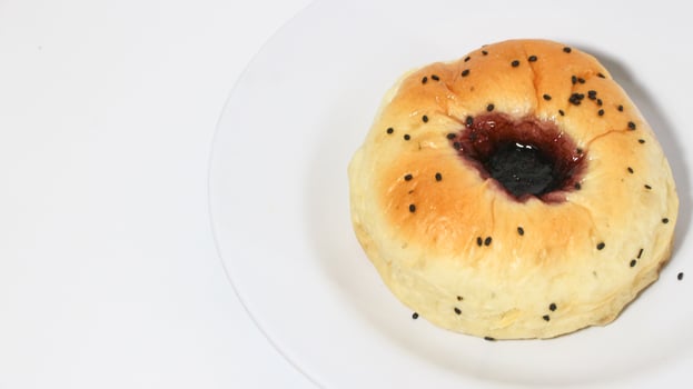 Indonesian bread filled with strawberries isolated on white background. Selective focus photo