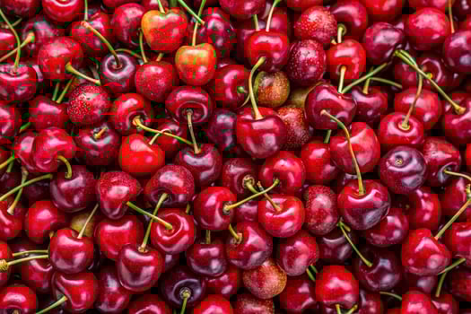 Background filled with the close-up details of ripe maroon cherries photo