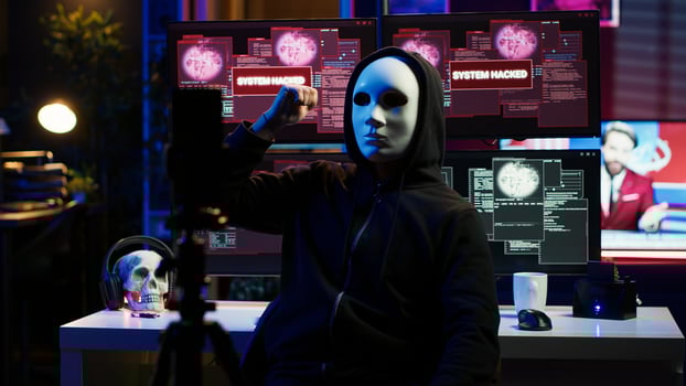Dissident social justice crusader doing online activism, wearing anonymous masks and filming in underground bunker, blackmailing government after stealing secret military documents, camera A photo