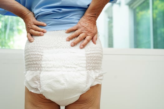 Asian senior woman patient wearing adult incontinence diaper pad in hospital. photo