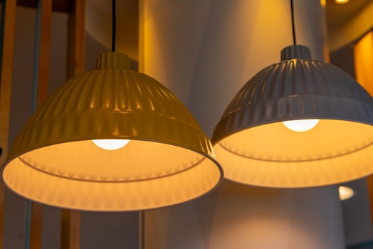 yellow and white hanging lamps with light bulbs in a modern interior photo