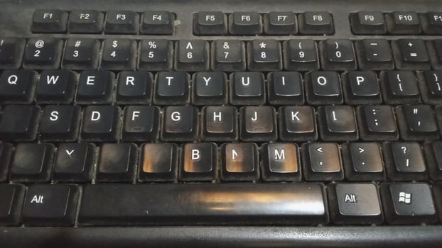 Alphabet letters on a working keyboard shot from under a lamp photo