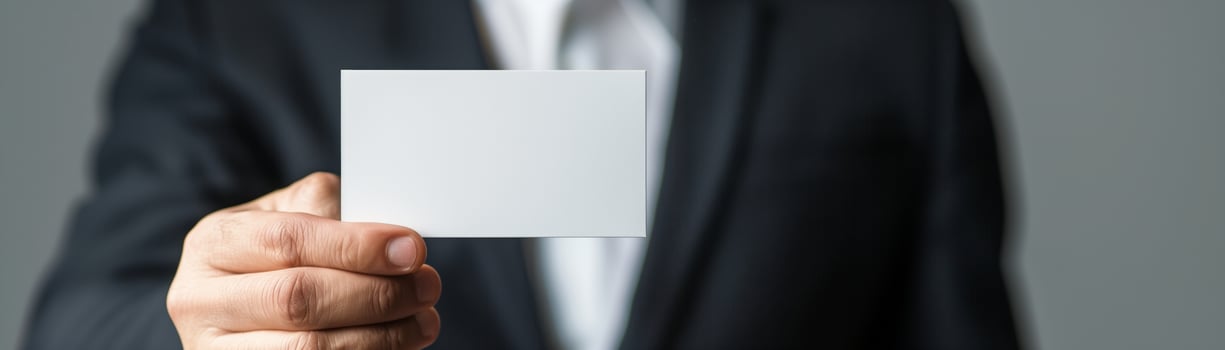 Businessman in suit holding blank business card, ready for customization. Perfect for corporate identity, business networking concepts. photo