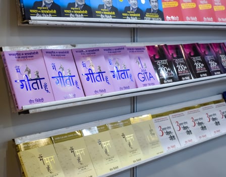 New Delhi, India, February 17 2024 - Variety of Books on shelf inside a book-stall at Delhi International Book Fair, Selection of books on display in Annual Book Fair at Bharat Mandapam complex photo