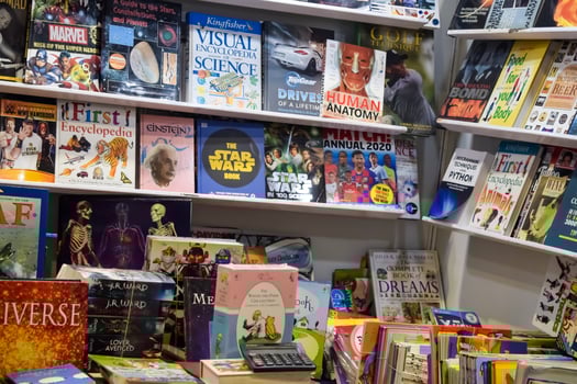 New Delhi, India, February 17 2024 - Variety of Books on shelf inside a book-stall at Delhi International Book Fair, Selection of books on display in Annual Book Fair at Bharat Mandapam complex photo