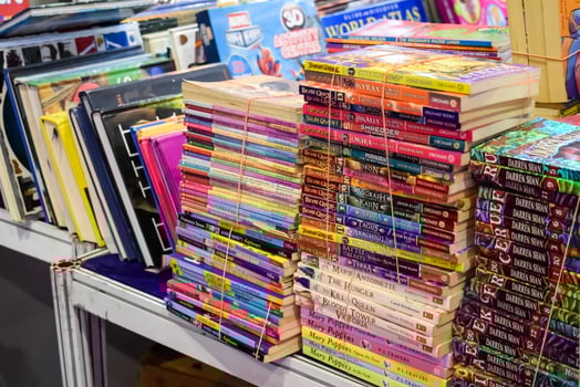 New Delhi, India, February 17 2024 - Variety of Books on shelf inside a book-stall at Delhi International Book Fair, Selection of books on display in Annual Book Fair at Bharat Mandapam complex photo