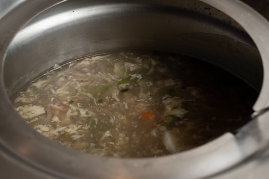 a pot of soup with a spoon in it photo