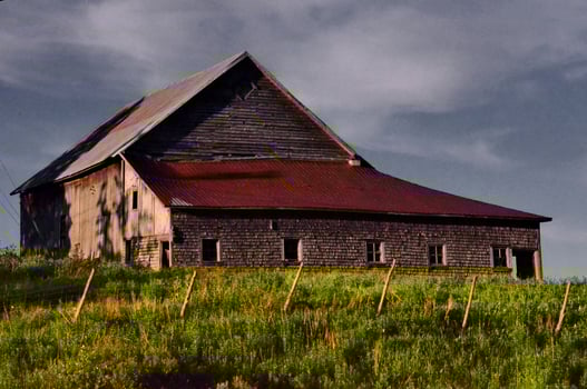 Rustic Wooden Barn With Red Roof in a Rural Setting Under Cloudy Skies in St-Ludger, Quebec, Canada photo