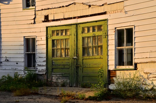 Weathered Wooden Double Doors on Old White House in Rural Setting in St-Ludger, Quebec, Canada photo