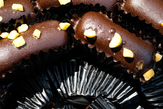 Photography of Chocolate Cookies wrapped in black paper background. Textured Detail of cookies in the jar. Graphic Resources. Food Photography. Cookies and pastries. Food Photography Concept. photo