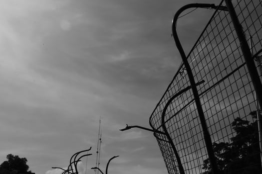 Black and white iron fence against the sky. Monochrome of exterior on public park. Graphic Resources. Monochrome Background Photography. Light Shadow Photography Concept. photo