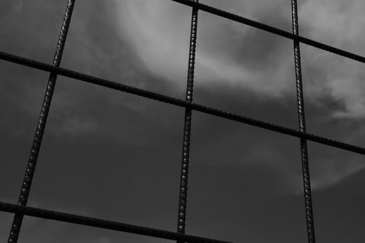 Black and white iron fence with rectangular weave. Monochrome of exterior on public park. Graphic Resources. Monochrome Background Photography. Light Shadow Photography Concept. photo