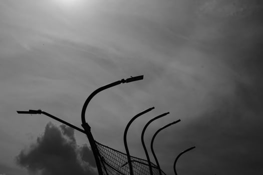 Black and white iron fence against the sky. Monochrome of exterior on public park. Graphic Resources. Monochrome Background Photography. Light Shadow Photography Concept. photo