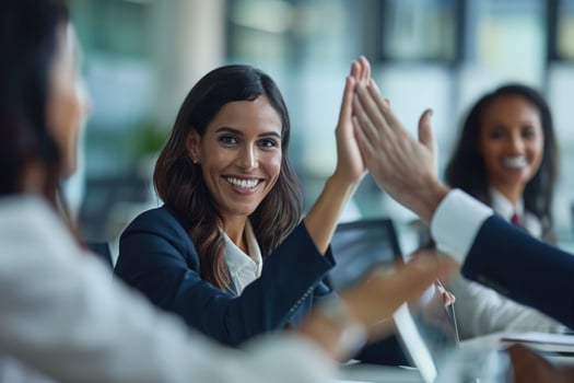 Businesswoman giving a high five to male colleague in meeting. photo