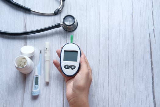 high angle view of women holding diabetic measurement tools photo