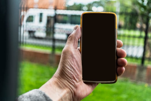 Male hand holding cell phone photo