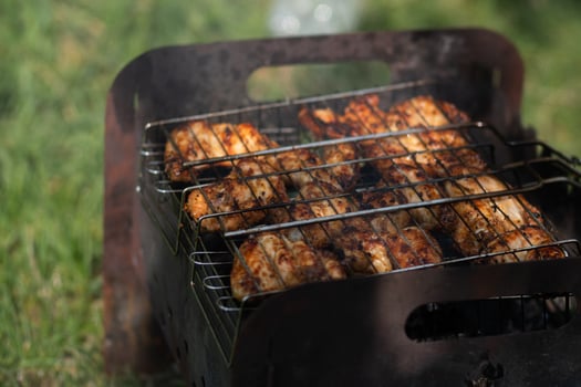 Chicken wings grilled on the grill in a BBQ grate photo