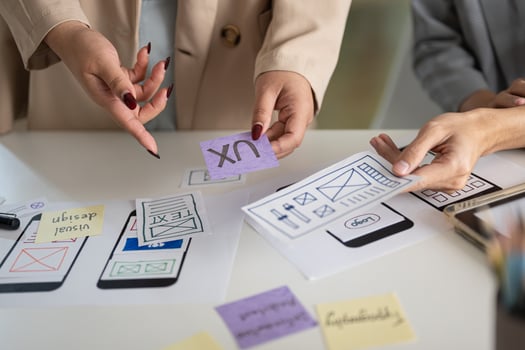 A cropped shot of a group of UX and UI graphic designers working in the meeting. photo