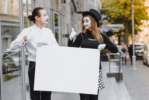 couple funny mimes holding sign photo