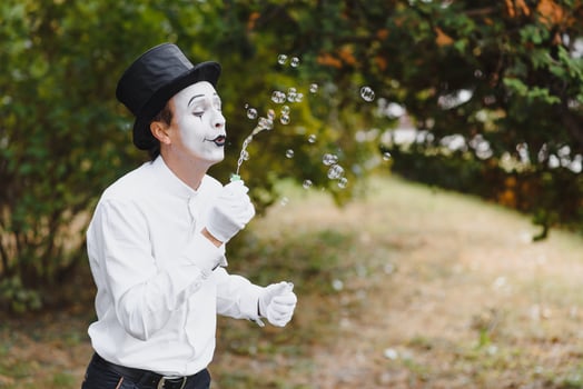 Mime artist blowing a bubble photo