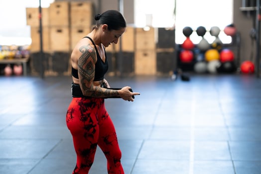 Strong woman attaching a belt to weightlifting photo