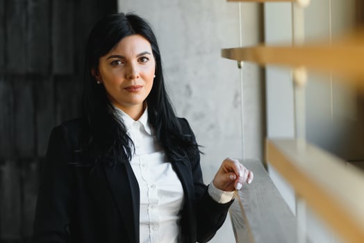 Smiling likable sincere and charming business woman financial executive type portrait inside commercial building. stylish brunette business woman in office photo