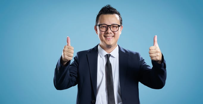 Confident businessman giving double thumbs up photo
