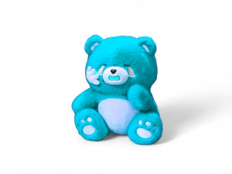 crying blue teddy bear on a white background photo