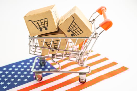 Box with shopping online cart logo and USA America flag, Import Export Shopping online or commerce finance delivery service store product shipping, trade, supplier. photo