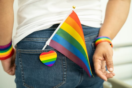 Woman holding LGBT rainbow colorful flag, symbol of lesbian, gay, bisexual, transgender, human rights, tolerance and peace. photo