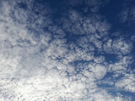 Beautiful white clouds on deep blue sky background. Large bright soft fluffy clouds are cover the entire blue sky. photo