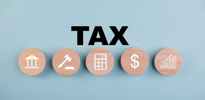 Tax with Saving Bank and wooden block cube concept, , tax payment optimisation business finance, wooden home with taxes icon on technology screen, income tax and property, corporations such as VAT photo
