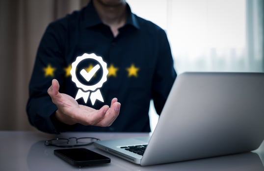 Quality assurance of business services, Businessman Hand shows the sign of the top service Quality assurance in Black background , Guarantee, Standards, ISO certification and standardization concept. photo