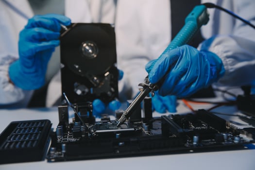 Close up of Technician measuring voltage electronic circuit board television, Service after sale fix electric equipment within insurance. photo