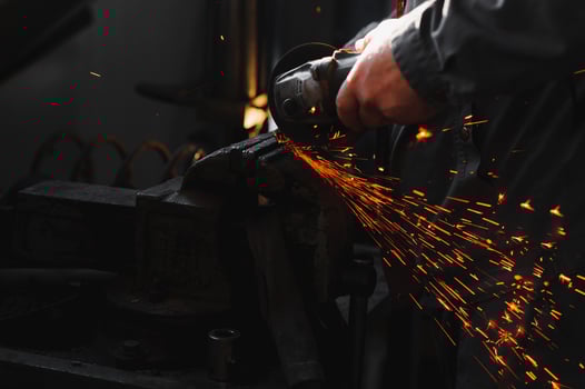 sawing metal. sparks frying over the working table during metal grinding photo