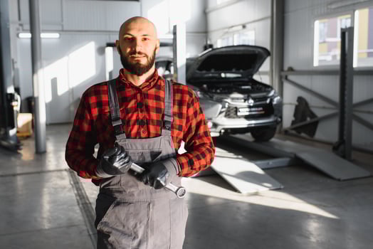 Auto mechanic working at auto repair shop photo
