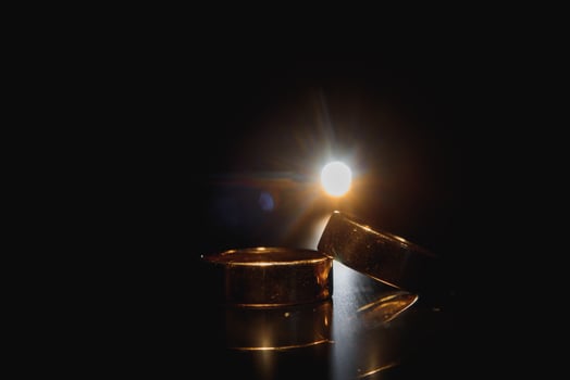 Beautiful wedding gold rings on dark background photo