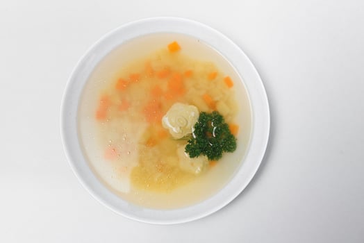 Bean soup with meatballs, vegetables and dill photo