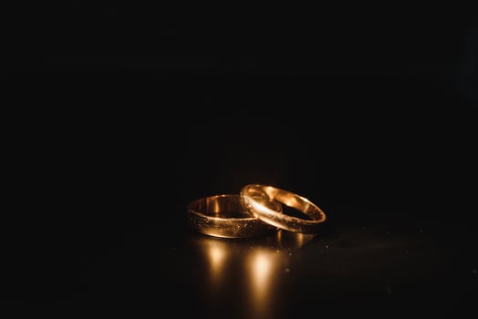 Beautiful wedding gold rings on dark background photo