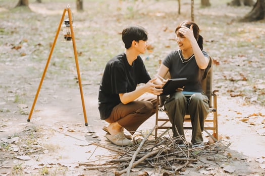 Asian couple sweet in tent inside on they camping trip, traveller relax and sleep togather in out door and camping trip photo