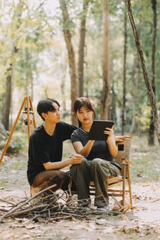 Asian couple sweet in tent inside on they camping trip, traveller relax and sleep togather in out door and camping trip photo