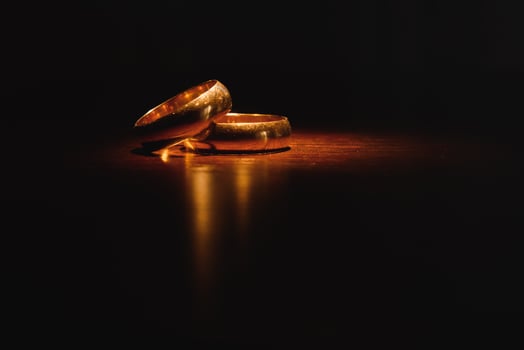 Beautiful wedding gold rings on dark background photo