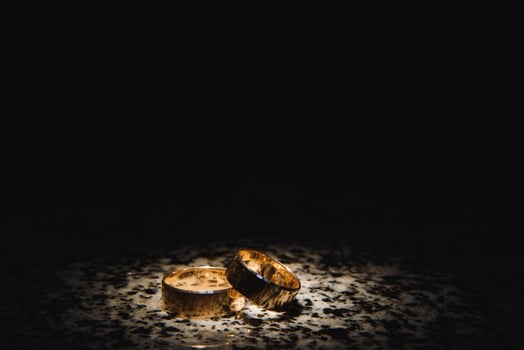 Beautiful wedding golden rings on dark background photo