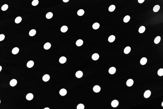 Vintage polka dot textile background texture, white dots on black luxury fabric design pattern photo