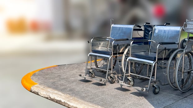 Wheel chairs for disability or injured person on dark gray footpath photo