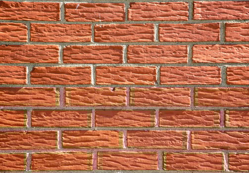 Close-Up View of Red Brick Wall With Mortar photo