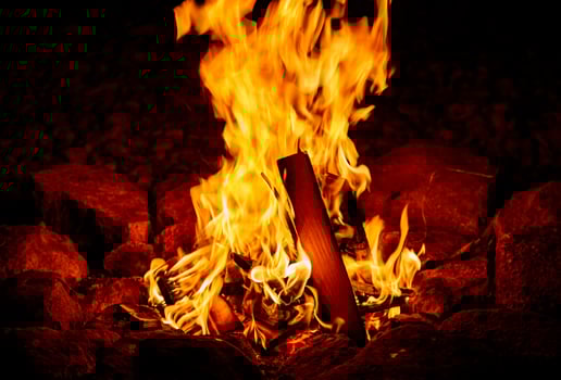Bright Orange Flames Burning in a Campfire at Night photo