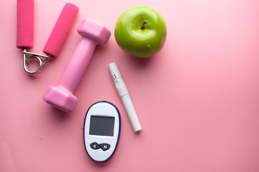 blood sugar measurement for diabetes with apple and dumbbell photo