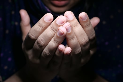 muslim women with head scarf praying, close up photo
