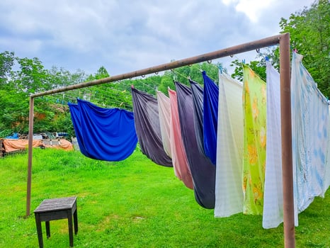 Multi- colored laundry drying on lines in the courtyard of a house. Czech photo